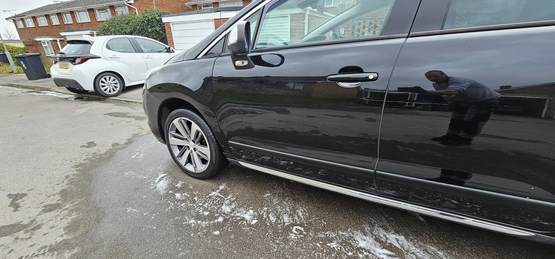 Black car exterior being cleaned by Platinum Car Cleaning